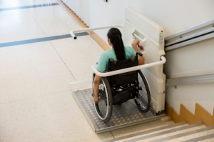 person using Stair Accessible elevator to go down the stairs